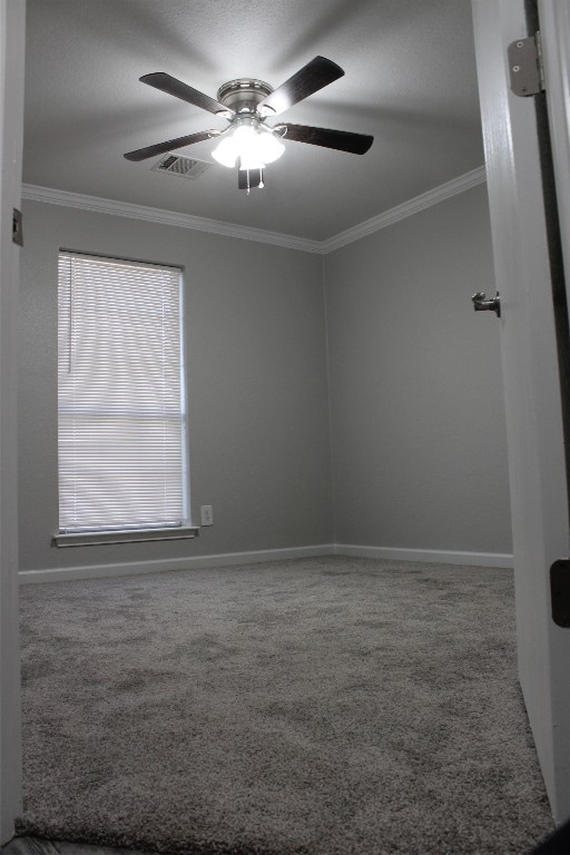 carpeted empty room featuring crown molding and ceiling fan