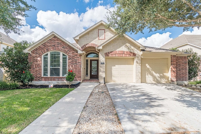 view of front of home with a front yard and a garage