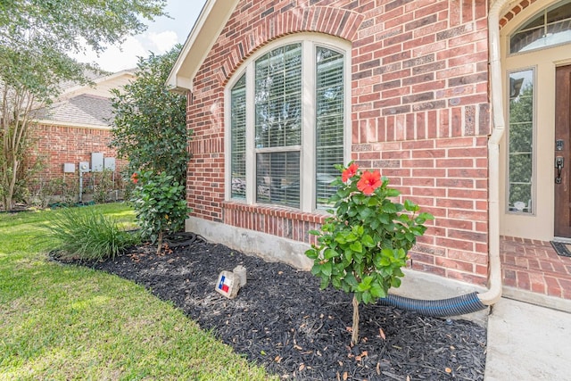 entrance to property featuring a lawn