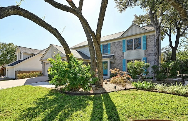 view of front facade with a garage and a front lawn