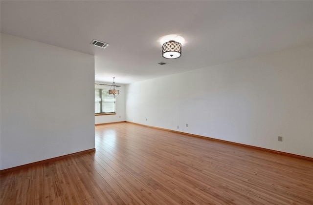 unfurnished room with light hardwood / wood-style flooring