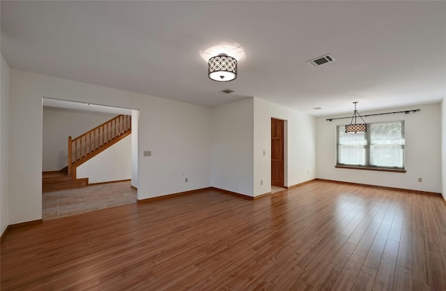 spare room featuring wood-type flooring