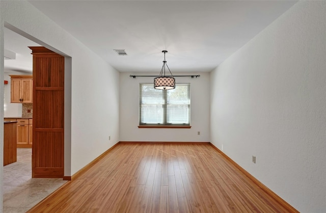 unfurnished dining area featuring light hardwood / wood-style flooring