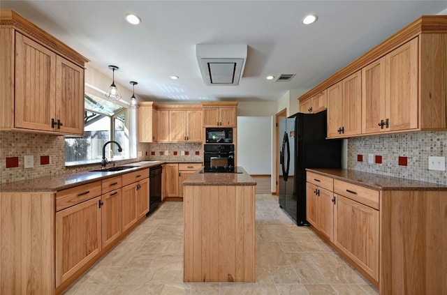 kitchen featuring decorative backsplash, dark stone countertops, sink, black appliances, and a center island