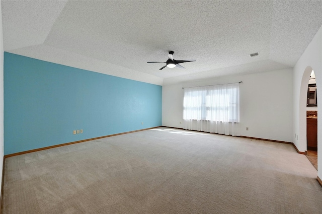 unfurnished room with light carpet, a textured ceiling, and ceiling fan