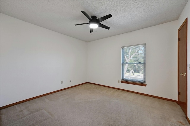 carpeted spare room featuring a textured ceiling and ceiling fan