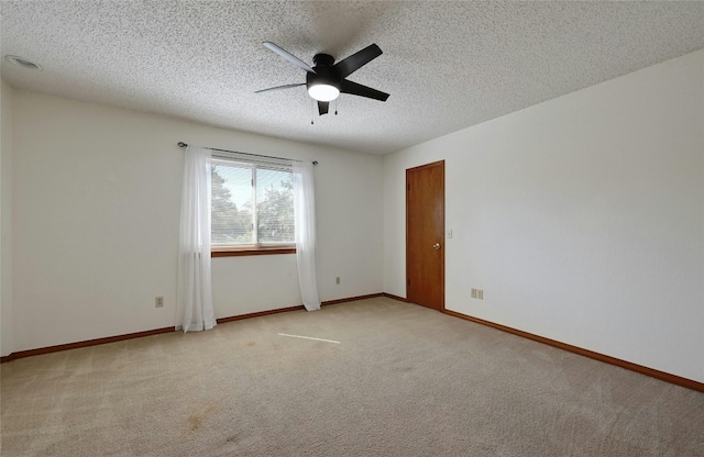 unfurnished room featuring light carpet, a textured ceiling, and ceiling fan