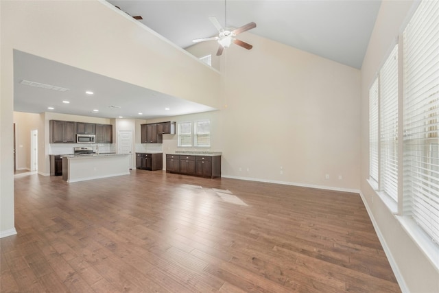 unfurnished living room featuring high vaulted ceiling, wood-type flooring, and ceiling fan