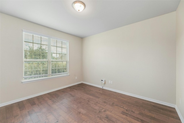 spare room featuring dark hardwood / wood-style flooring