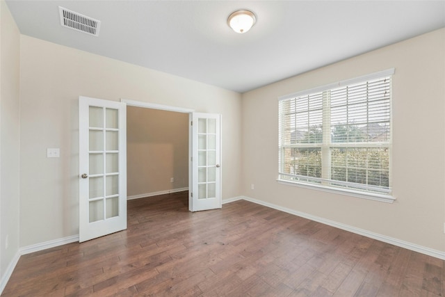 empty room with french doors and wood-type flooring