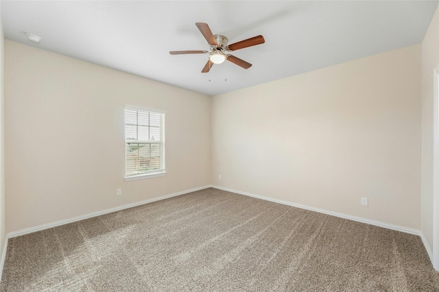 carpeted empty room featuring ceiling fan