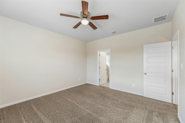 unfurnished bedroom with light carpet, ensuite bathroom, and ceiling fan