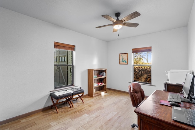 home office with ceiling fan and light wood-type flooring