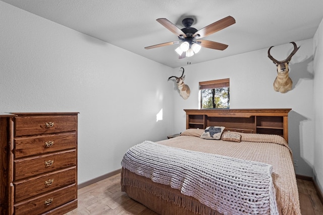 bedroom with ceiling fan and light hardwood / wood-style flooring