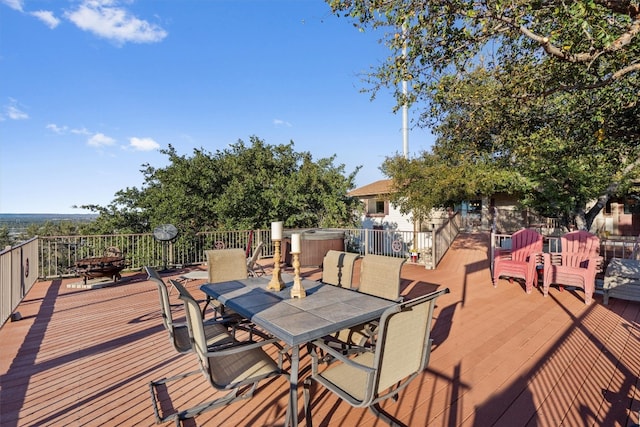 wooden deck featuring a hot tub