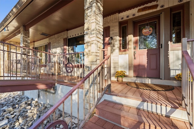 entrance to property featuring covered porch