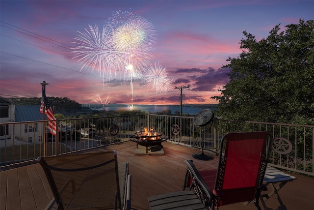 deck at dusk with an outdoor fire pit