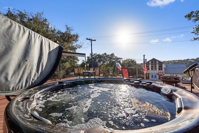 view of swimming pool with a hot tub