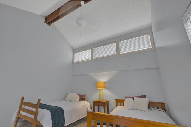 bedroom featuring ceiling fan and lofted ceiling with beams