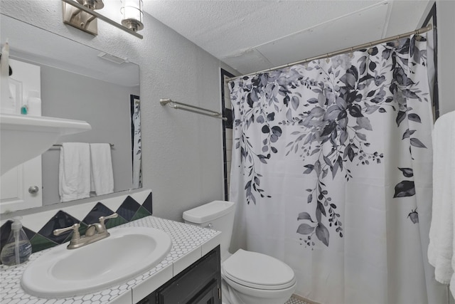 bathroom with toilet, vanity, and a shower with shower curtain