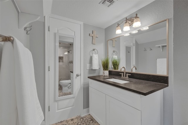 bathroom with toilet, vanity, a textured ceiling, and a shower with shower curtain