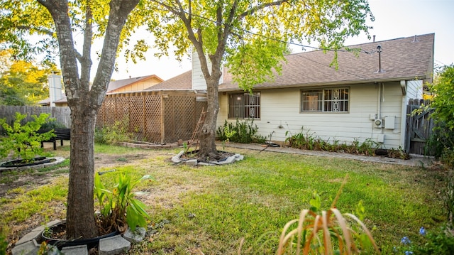 rear view of property featuring a lawn