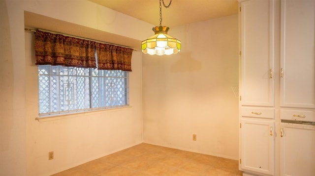 unfurnished dining area with light tile patterned floors