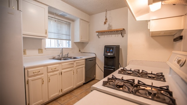 kitchen with hanging light fixtures, stove, dishwasher, white fridge, and sink