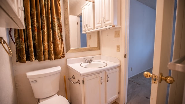 bathroom featuring toilet and vanity