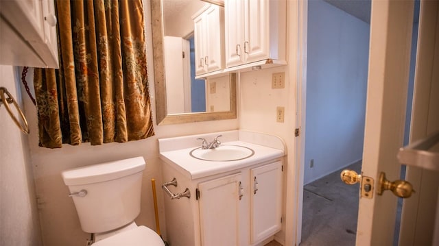 half bath featuring toilet and vanity