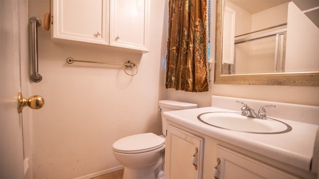 bathroom with vanity, toilet, and an enclosed shower