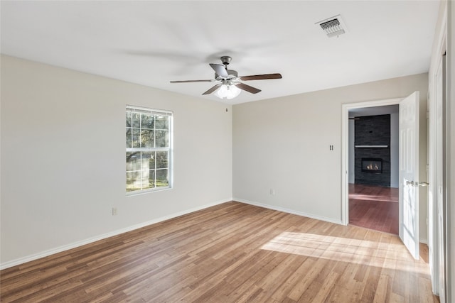 unfurnished room with light wood-type flooring and ceiling fan