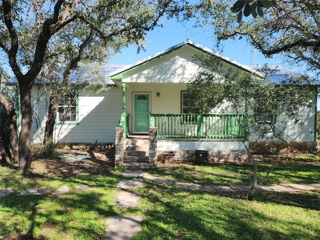 bungalow-style house with a front yard and covered porch