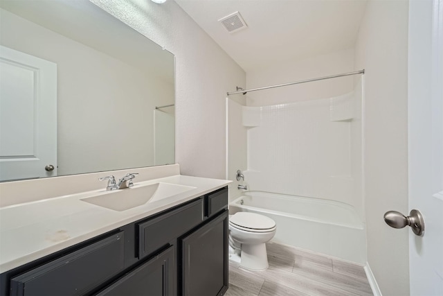 full bathroom featuring toilet, shower / tub combination, hardwood / wood-style flooring, and vanity