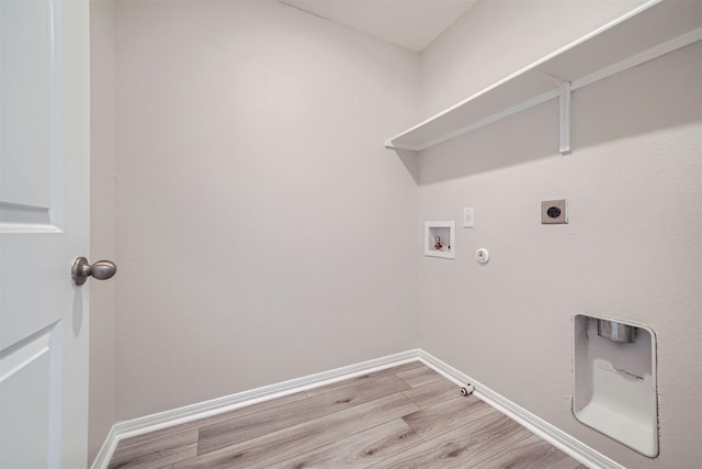 clothes washing area featuring hookup for a washing machine, gas dryer hookup, hookup for an electric dryer, and light wood-type flooring