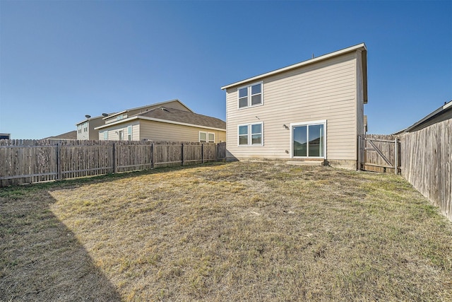 back of house featuring a yard