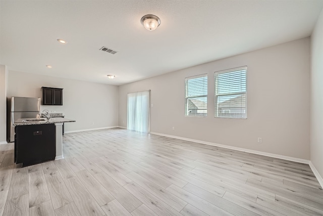 unfurnished living room featuring light hardwood / wood-style flooring