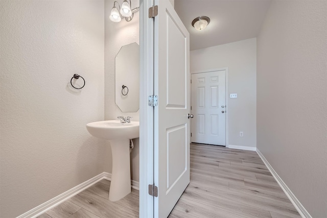 bathroom with hardwood / wood-style floors and sink