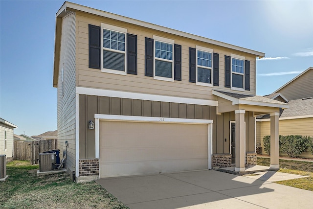 view of front facade with a garage and central AC