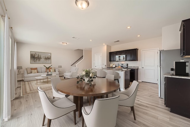 dining space with light hardwood / wood-style floors