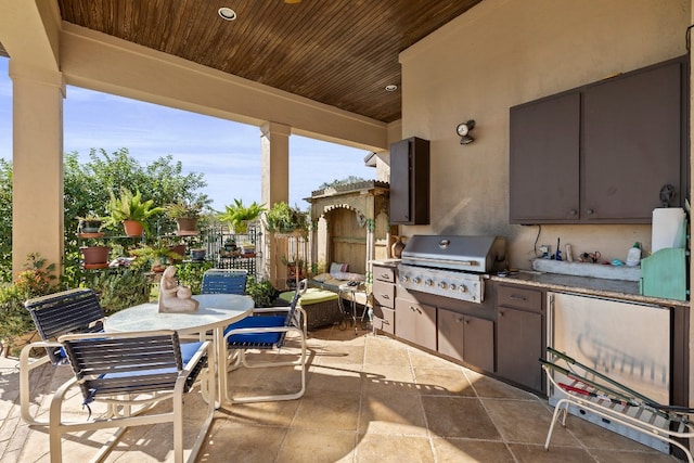 view of patio / terrace with area for grilling and a grill