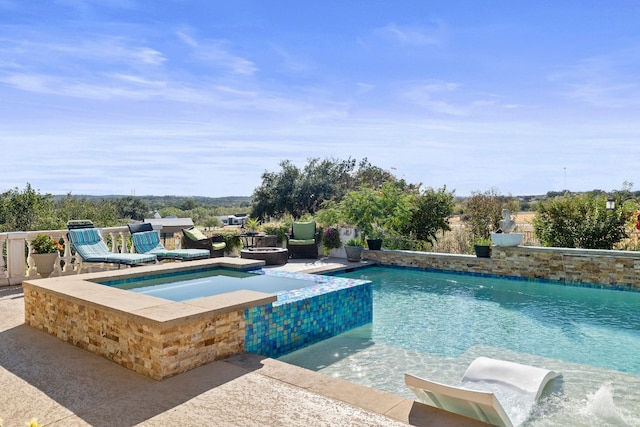 view of swimming pool featuring an in ground hot tub and a patio