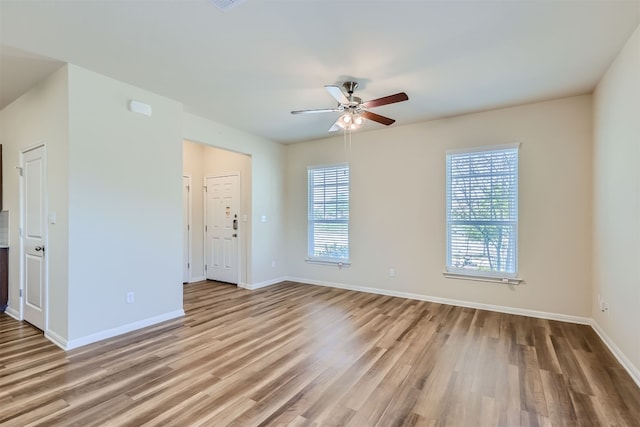 unfurnished room featuring light hardwood / wood-style floors and ceiling fan