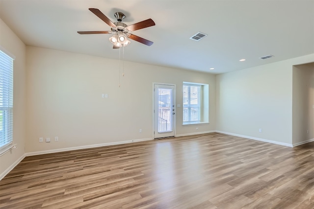 empty room featuring light hardwood / wood-style flooring and ceiling fan