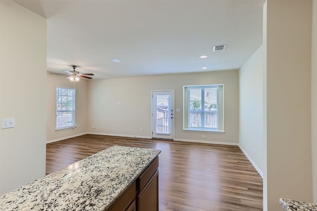 spare room with dark wood-type flooring and ceiling fan