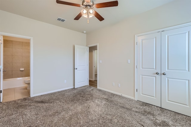 unfurnished bedroom with connected bathroom, ceiling fan, a closet, and carpet