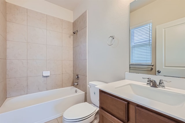 full bathroom featuring toilet, tiled shower / bath, and vanity