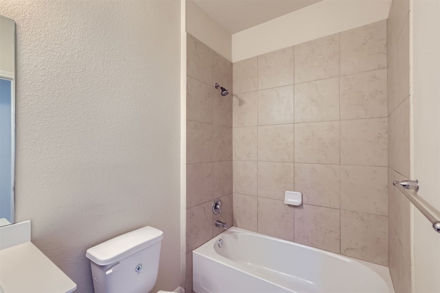 bathroom with tiled shower / bath combo and toilet