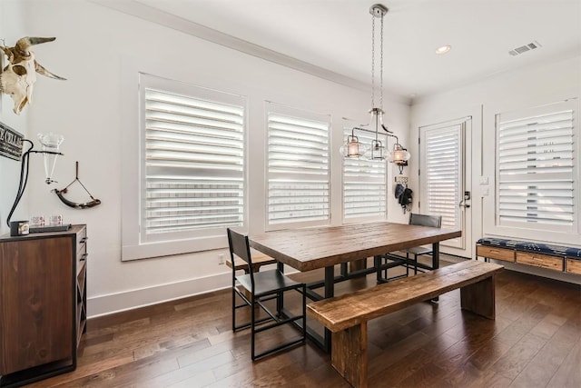 1100 Railroad Ave, Georgetown, TX 78626 - dining space featuring crown molding, dark wood-style flooring, baseboards, and visible vents