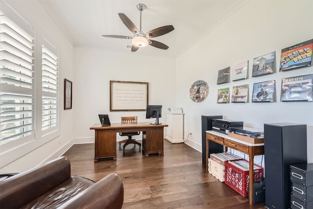 home office with dark wood-type flooring, ceiling fan, and crown molding